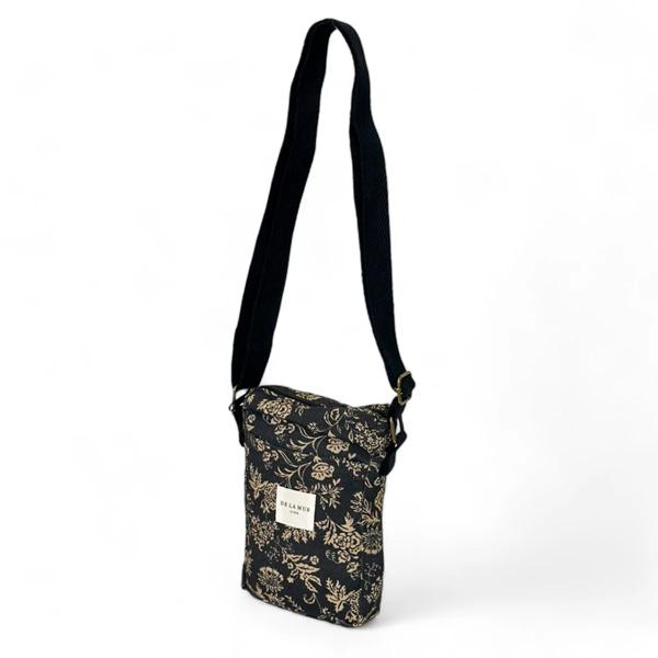 Bolso Porta Móvil Elisa De La Mur con estampado floral en tonos negro y beige.
